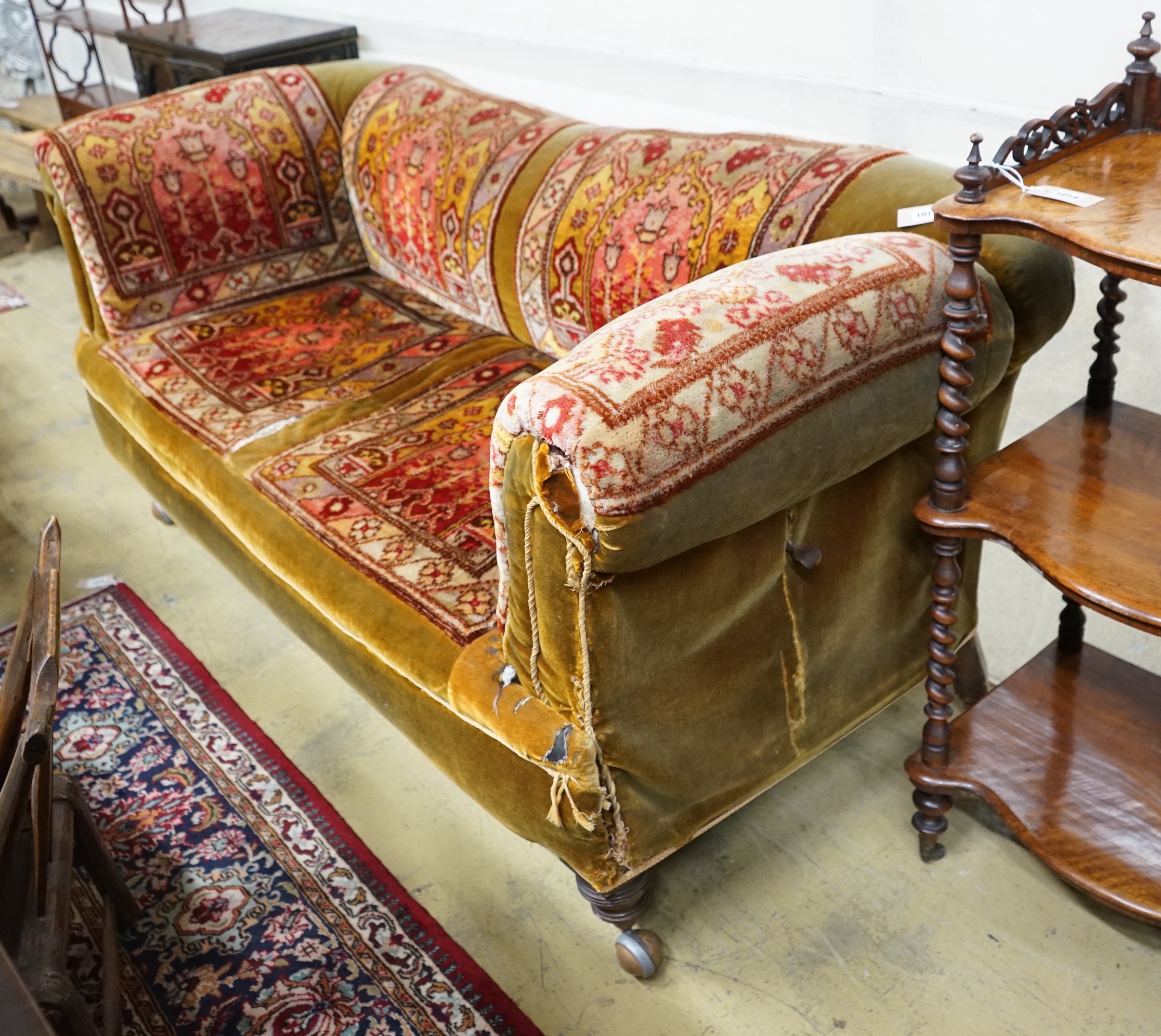 A late Victorian drop arm Chesterfield settee with carpet upholstery, length 175cm, width 78cm, height 80cm
